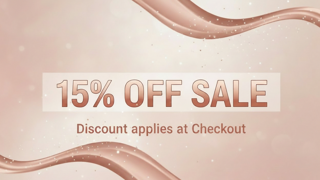 Promotional sale graphic with the text '15% OFF SALE' and 'Discount applies at Checkout' on a soft blush pink background with flowing metallic rose-gold ribbon shapes.
